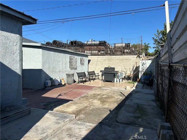 a view of a house with wooden fence