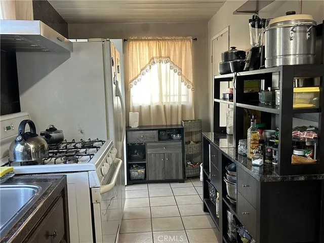 a kitchen with refrigerator and cabinets