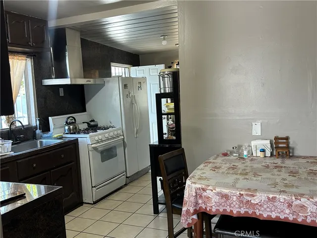 a bedroom with a bed and a refrigerator