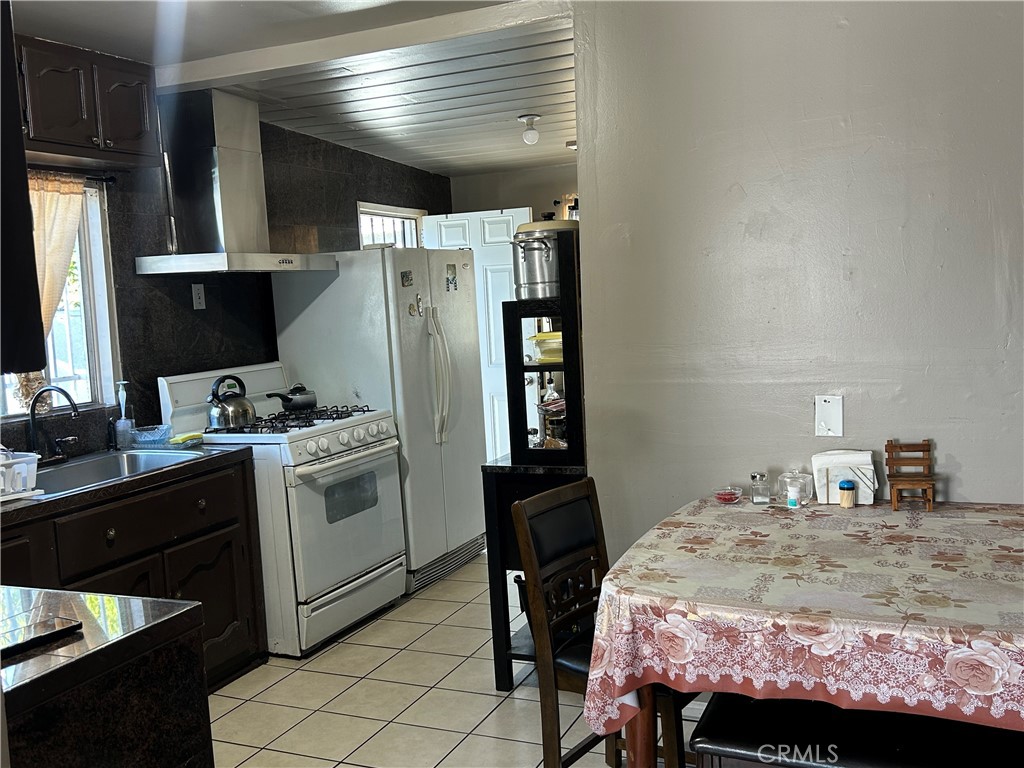 2011 East Elizabeth Street Compton, CA 90221 - Photo 9 of 19 a bedroom with a bed and a refrigerator