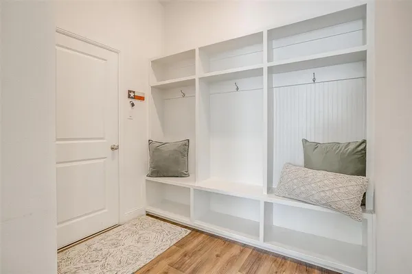 a bathroom with a granite countertop toilet a sink a mirror a bathtub and shower