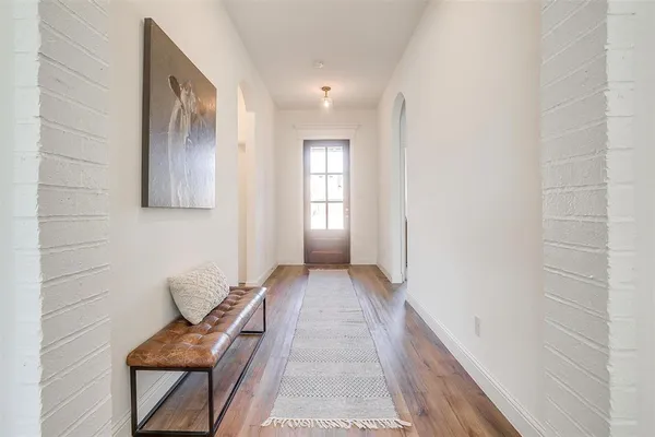a view of a dining room with furniture and a potted plant