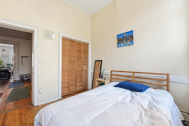 a bedroom with a bed and a large mirror