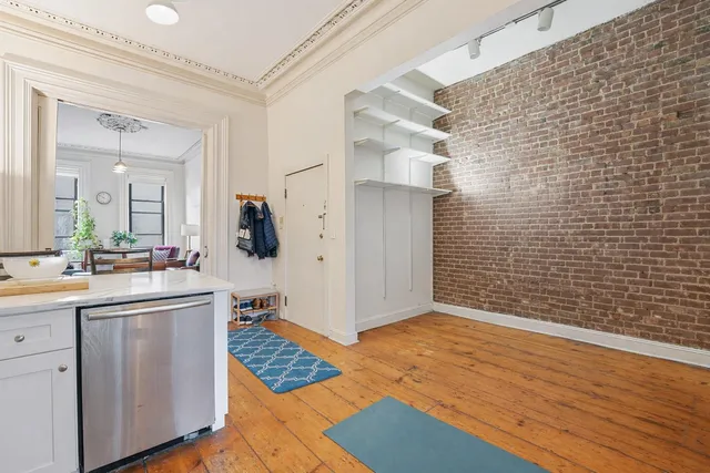 a view of kitchen with stainless steel appliances cabinets and wooden floor