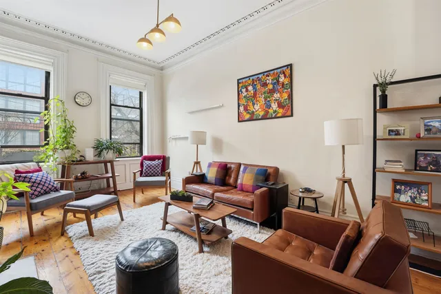 a living room with furniture and a book shelf