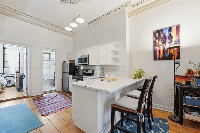 a view of a dining room with furniture and wooden floor