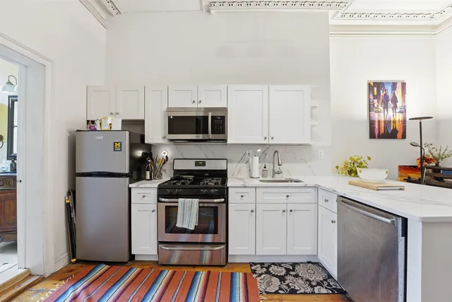 a kitchen with a sink stove and refrigerator