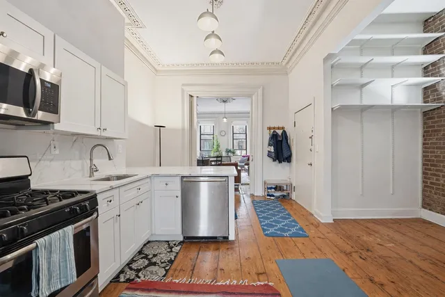 a kitchen with a sink stove and cabinets