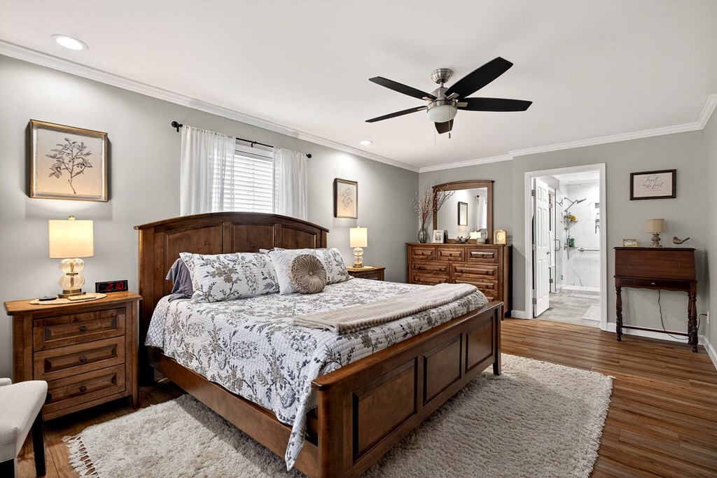 2195 Windle Community Road Cookeville, TN 38506 - Photo 12 of 22 a bedroom with a bed a dresser and a chandelier