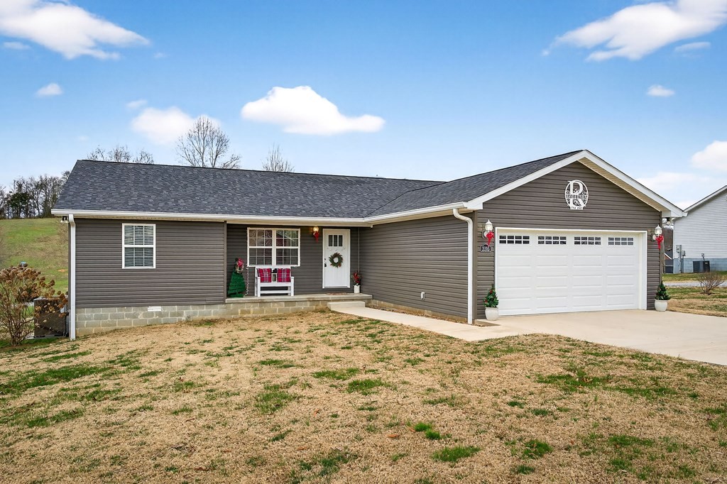 2195 Windle Community Road Cookeville, TN 38506 - Photo 2 of 22 a front view of a house with a yard and garage