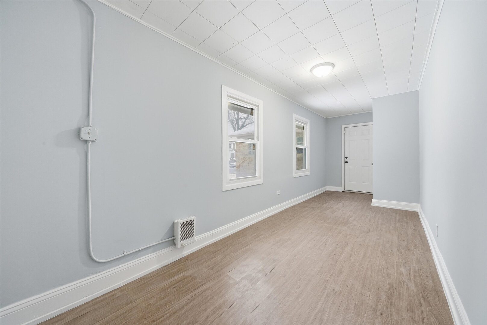 2658 West 83rd Street Chicago, IL 60652 - Photo 26 of 41 a view of an empty room with a window and wooden floor