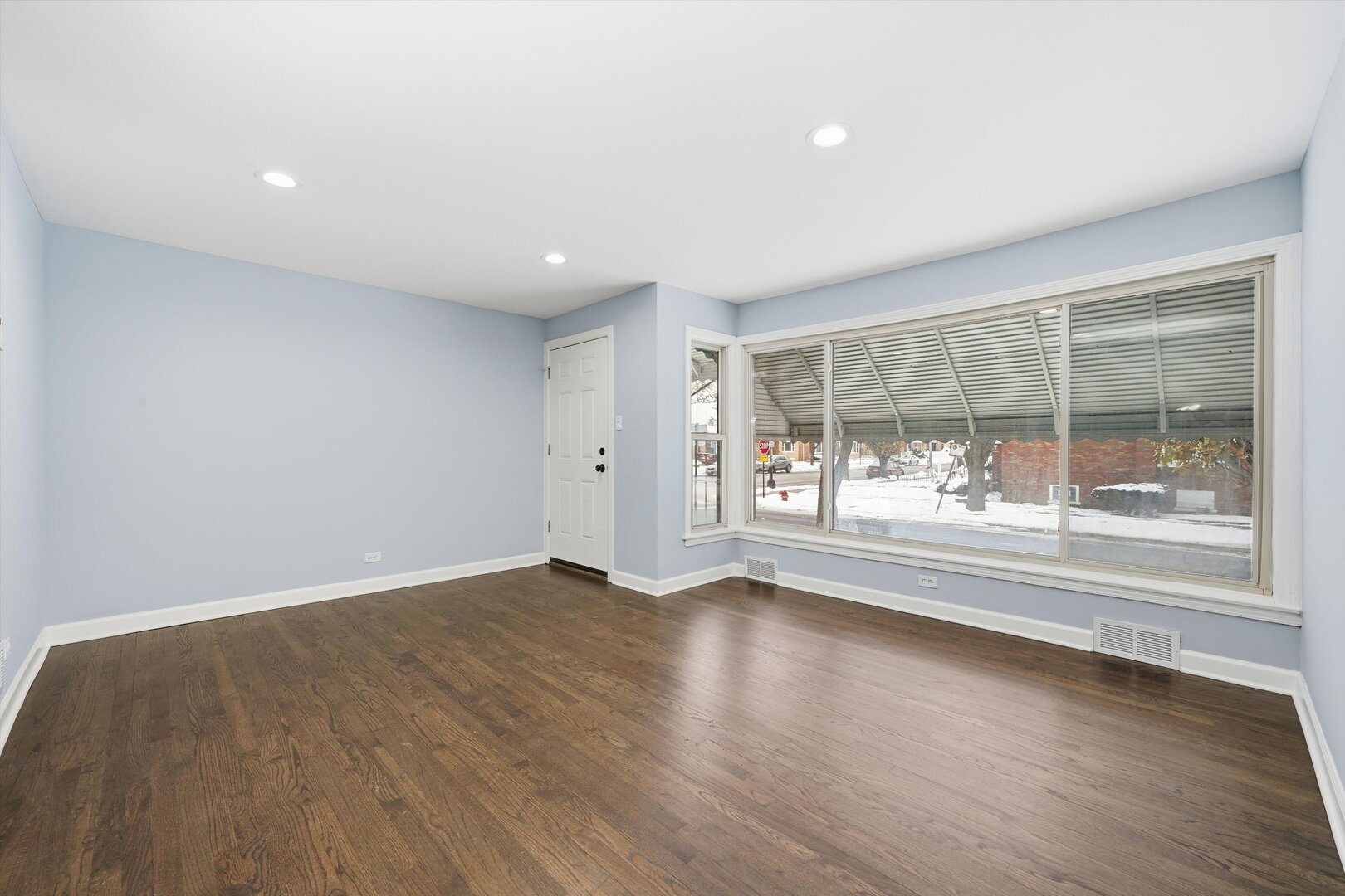 2658 West 83rd Street Chicago, IL 60652 - Photo 7 of 41 an empty room with wooden floor and a floor to ceiling window