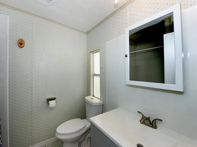 a bathroom with a toilet and a sink