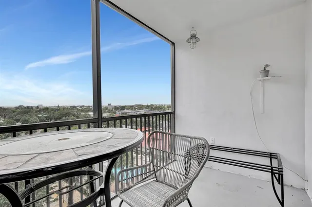 a view of a balcony with table and chairs
