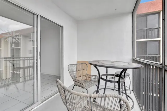 a view of a balcony with furniture