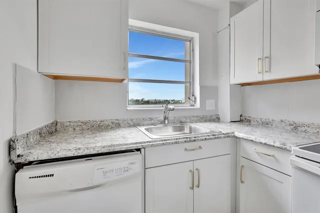 a kitchen with stainless steel appliances granite countertop a sink and cabinets
