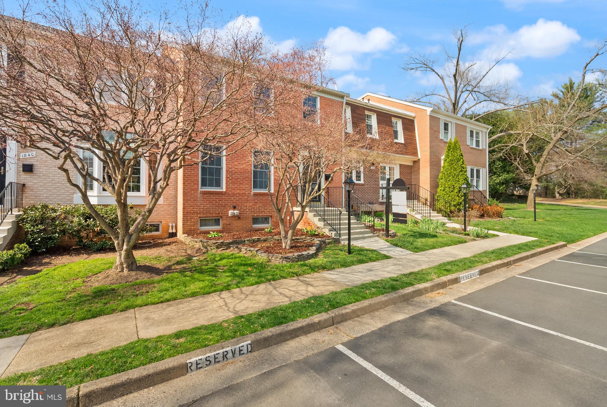 1838 Golf View Court Reston, VA 20190 - Photo 3 of 60 a view of a brick house with a yard and large tree