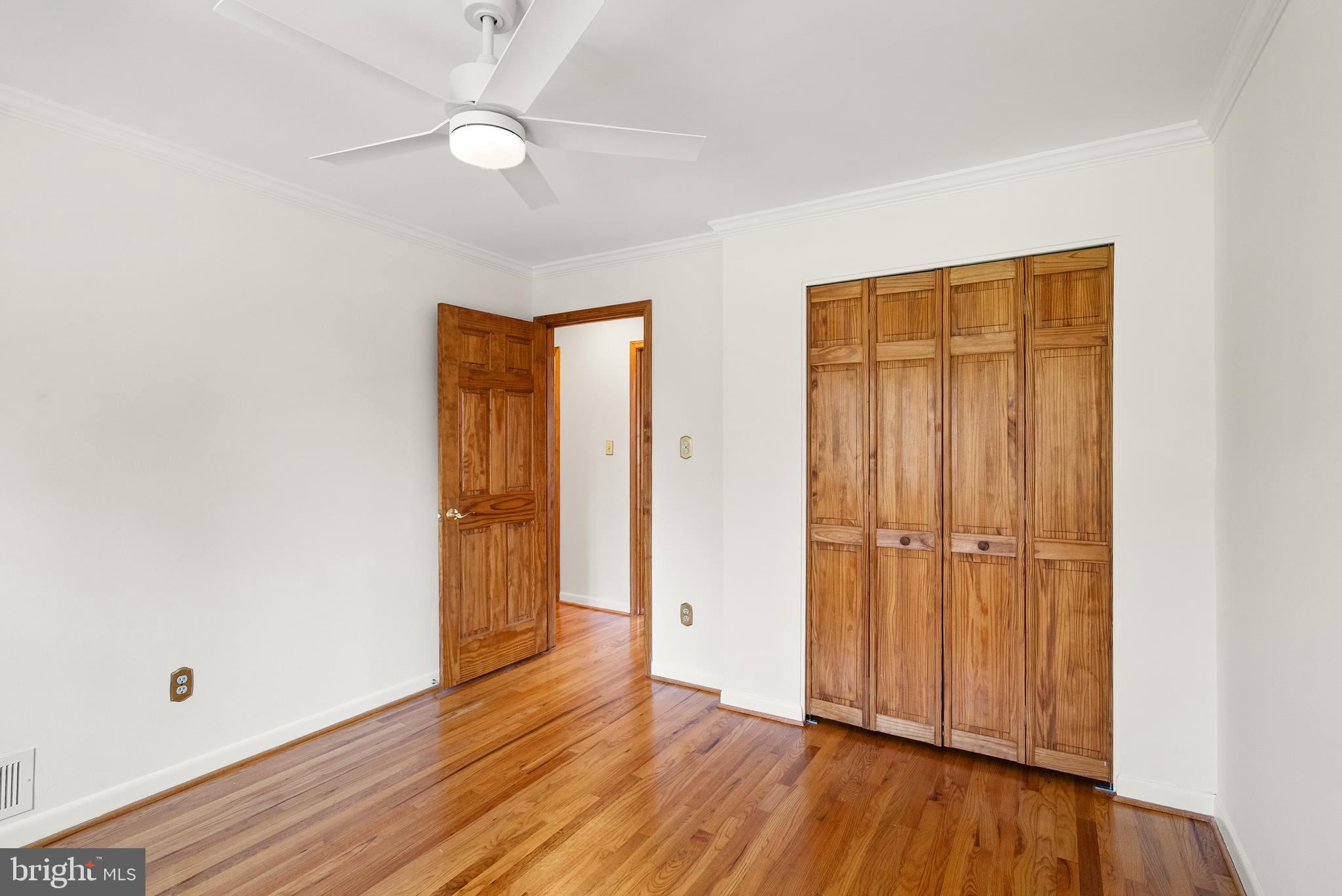 1838 Golf View Court Reston, VA 20190 - Photo 35 of 60 an empty room with wooden floor and a ceiling fan