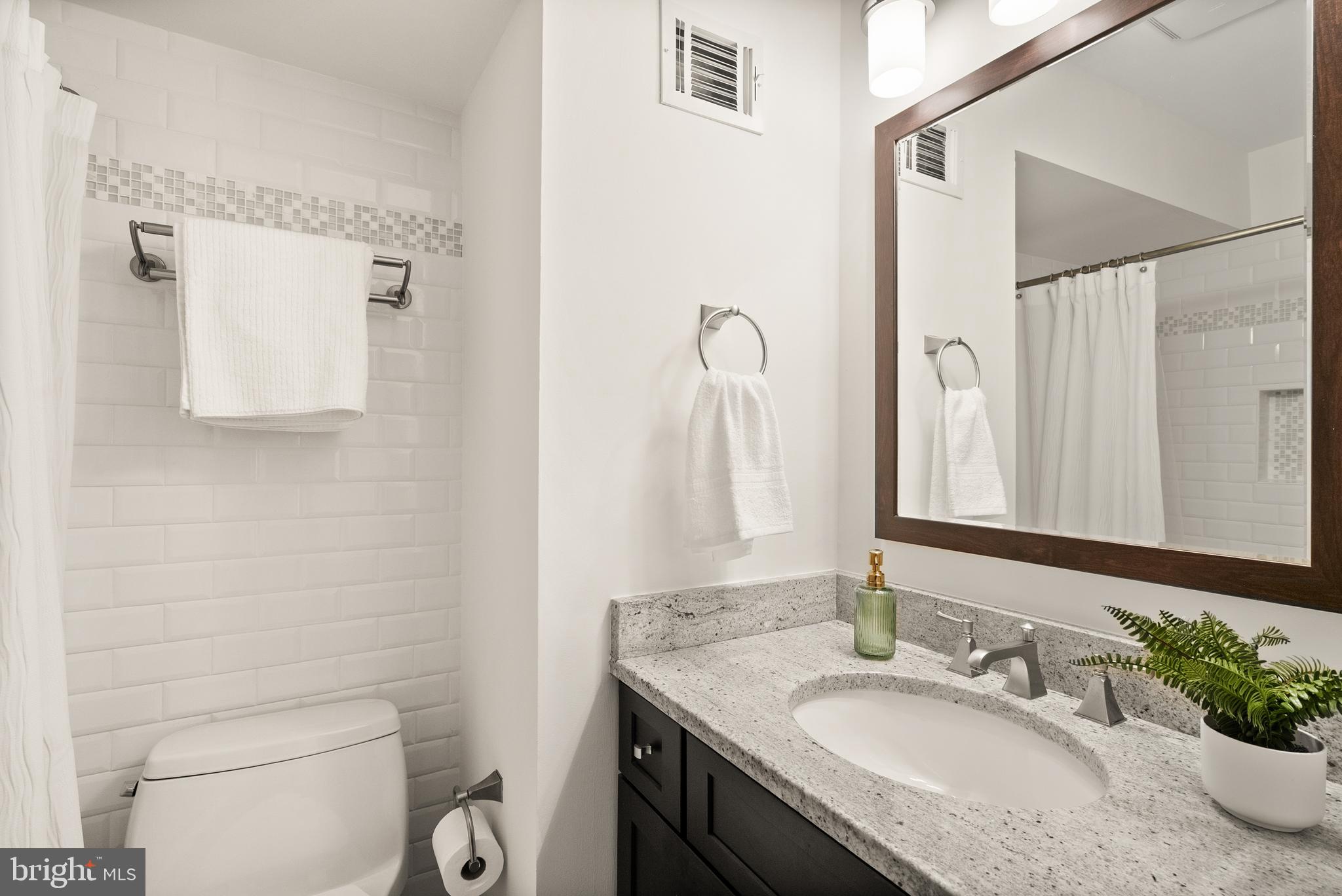 1838 Golf View Court Reston, VA 20190 - Photo 39 of 60 a bathroom with a granite countertop sink toilet and mirror