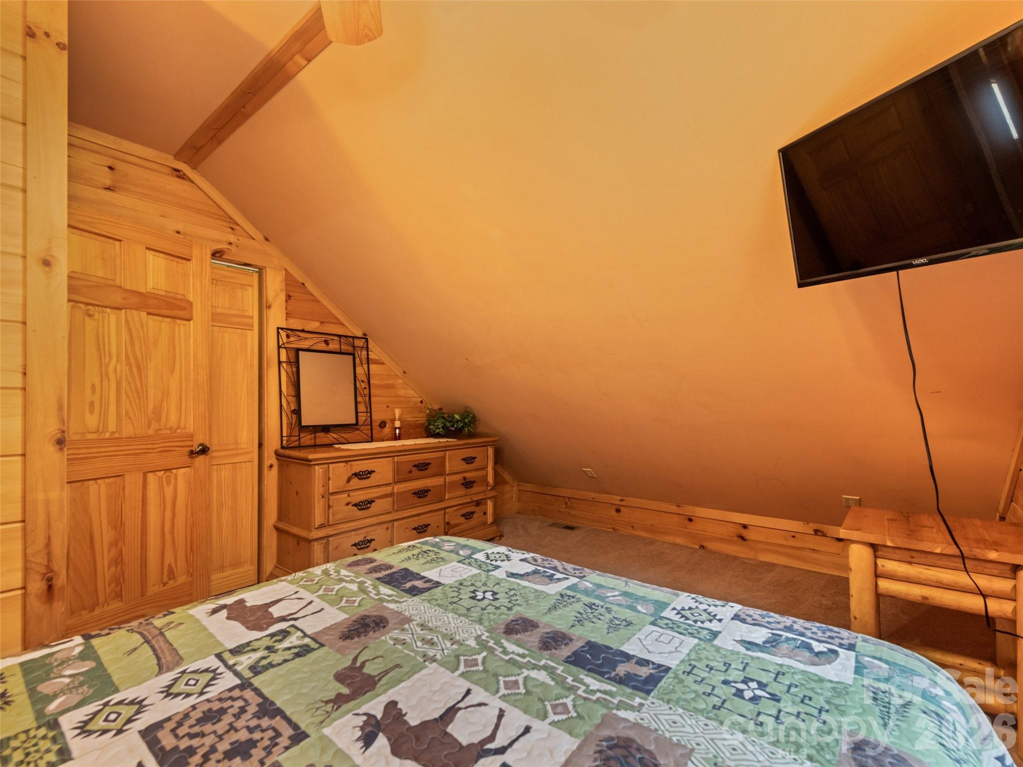 91 Copper Spur Road Maggie Valley, NC 28751 - Photo 18 of 29 a bedroom with a bed and a flat screen tv