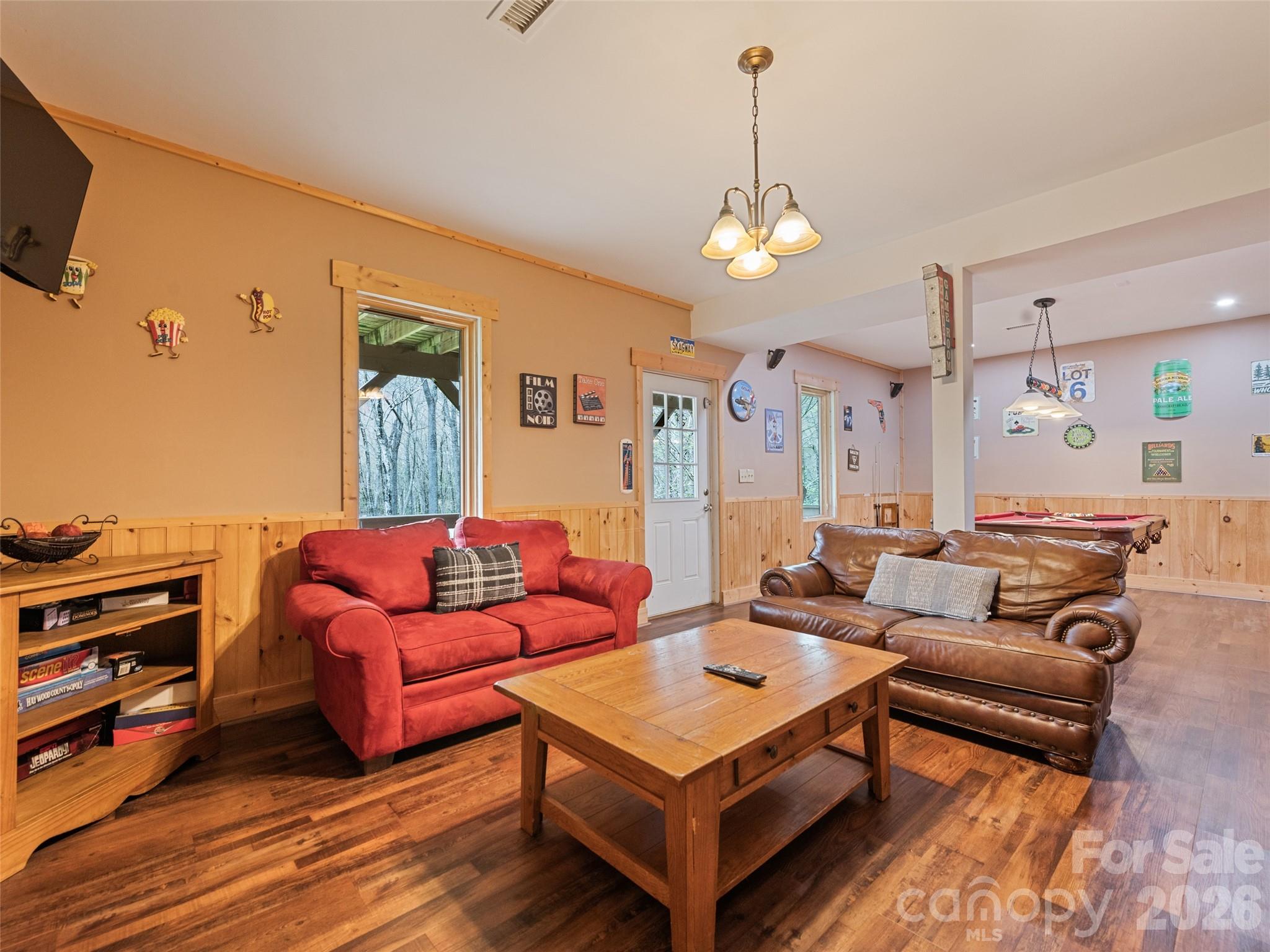 91 Copper Spur Road Maggie Valley, NC 28751 - Photo 20 of 29 a living room with furniture a ceiling fan and a window