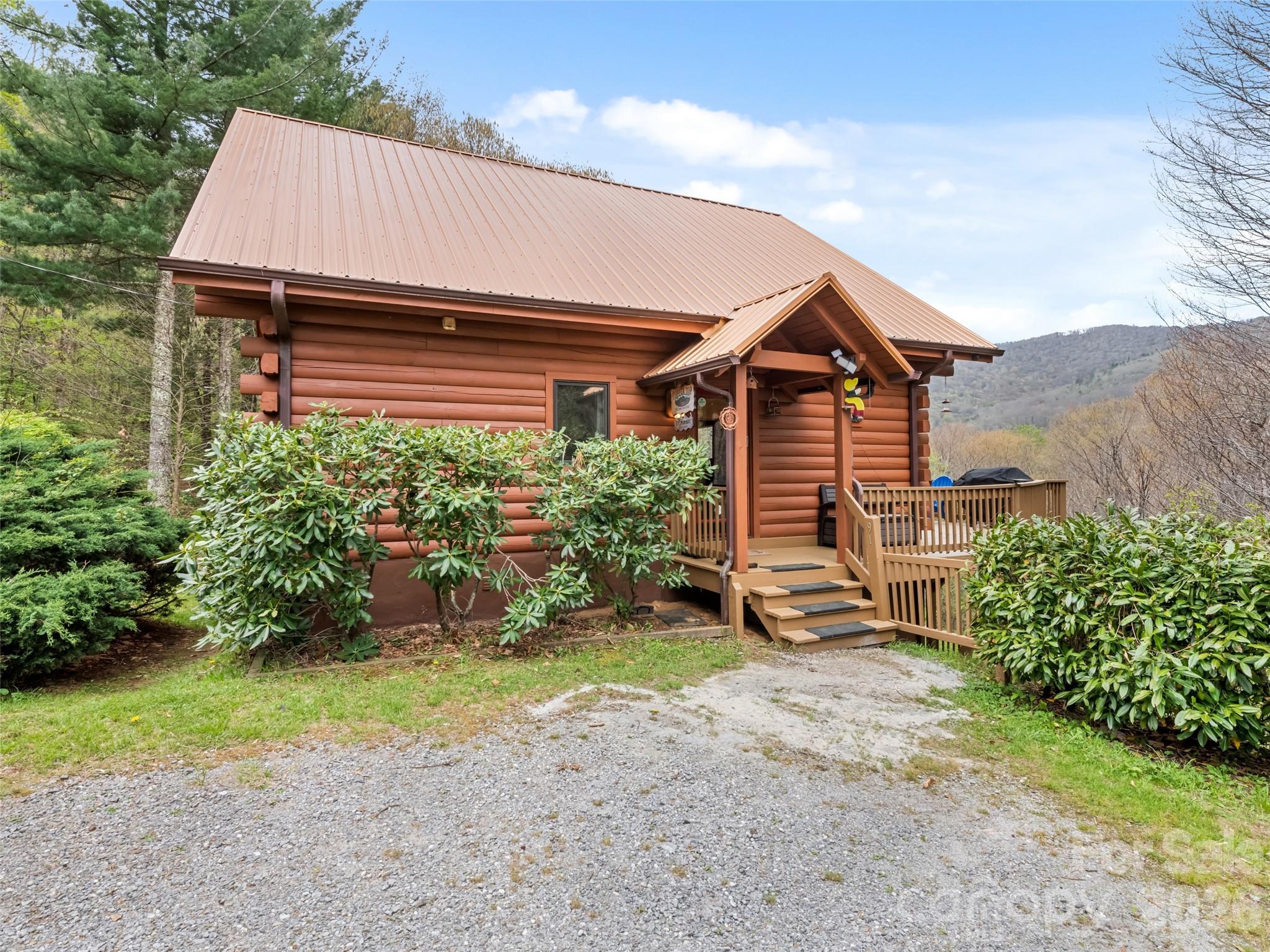 91 Copper Spur Road Maggie Valley, NC 28751 - Photo 2 of 29 a front view of a house with a garden