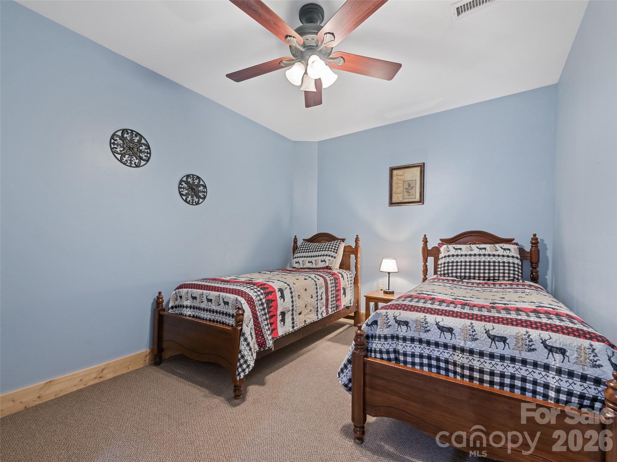 91 Copper Spur Road Maggie Valley, NC 28751 - Photo 25 of 29 a bedroom with a bed and a chandelier
