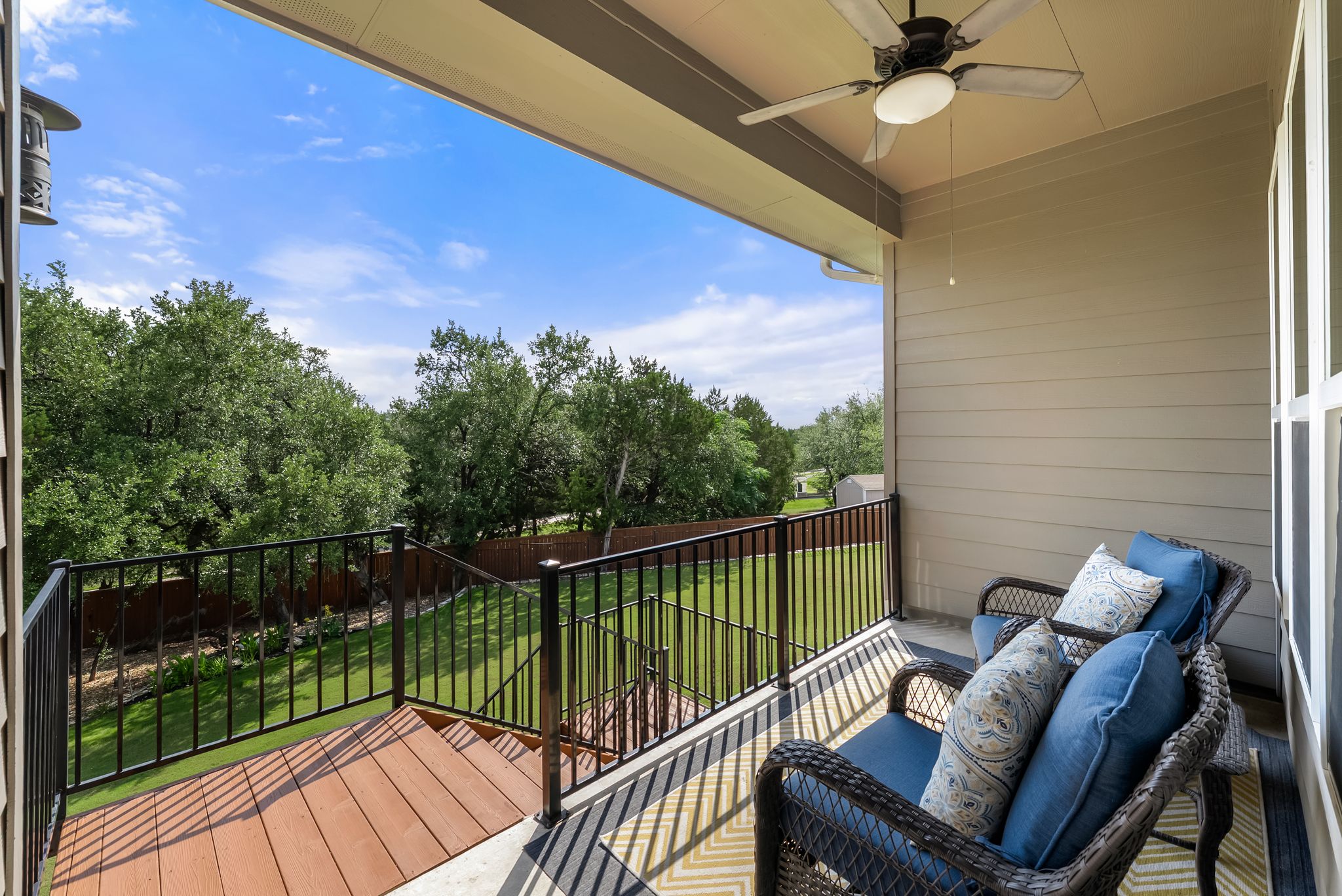 300 Prato Place Georgetown, TX 78628 - Photo 31 of 40 An inviting covered deck offers serene views of the verdant yard and mature trees, perfect for outdoor relaxation.