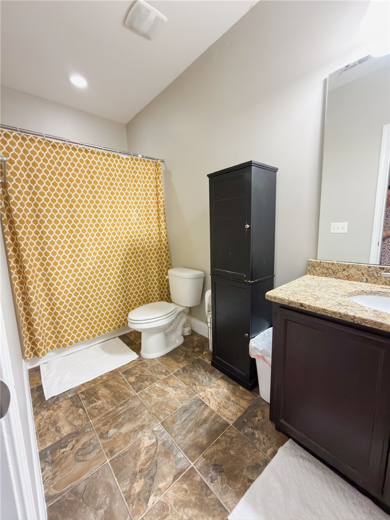 2409 Watkins Road Anderson, SC 29625 - Photo 41 of 44 This bright Basement bathroom features a vanity with granite counters and tiled flooring, offering both style and utility.