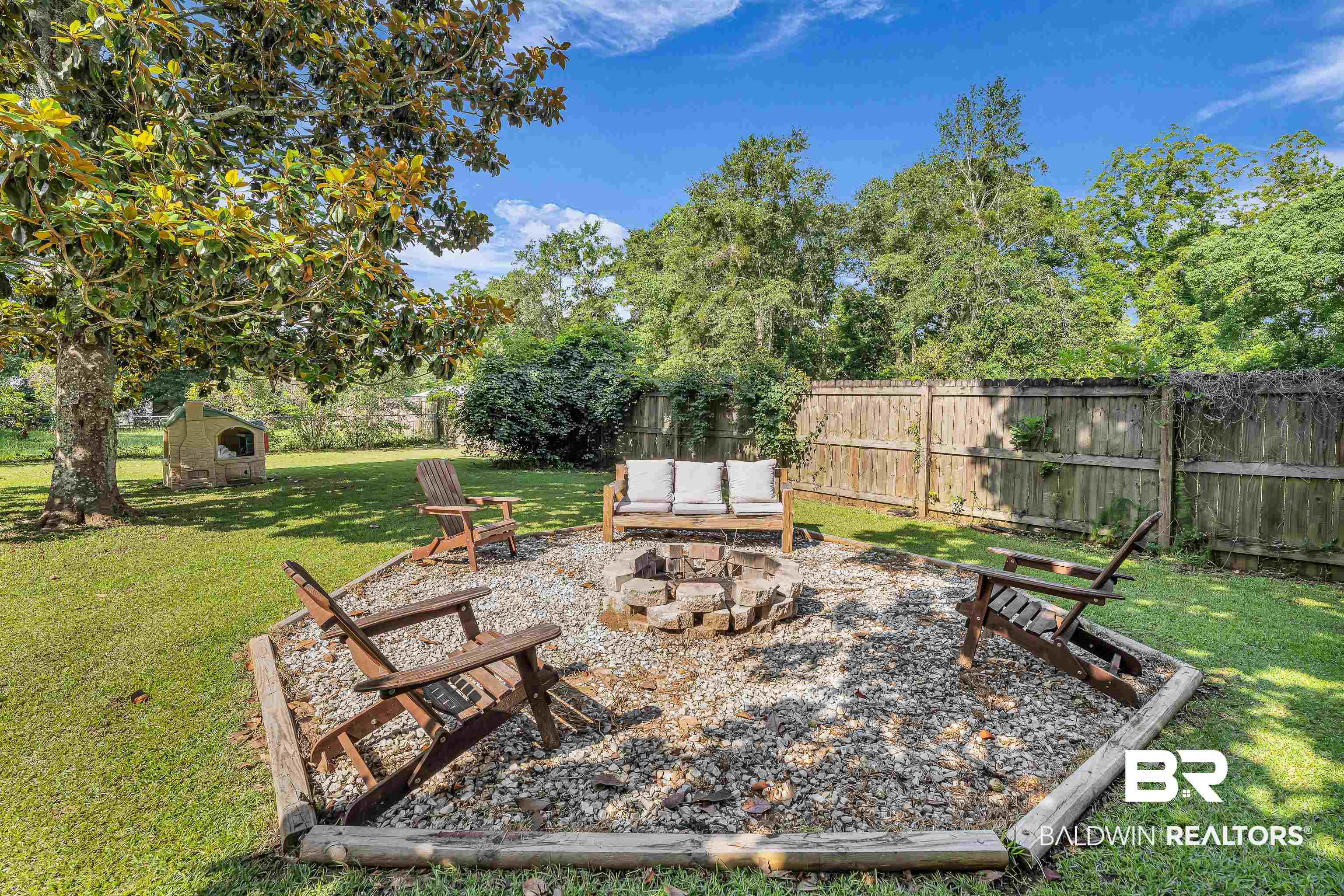 View of backyard featuring a fire pit
