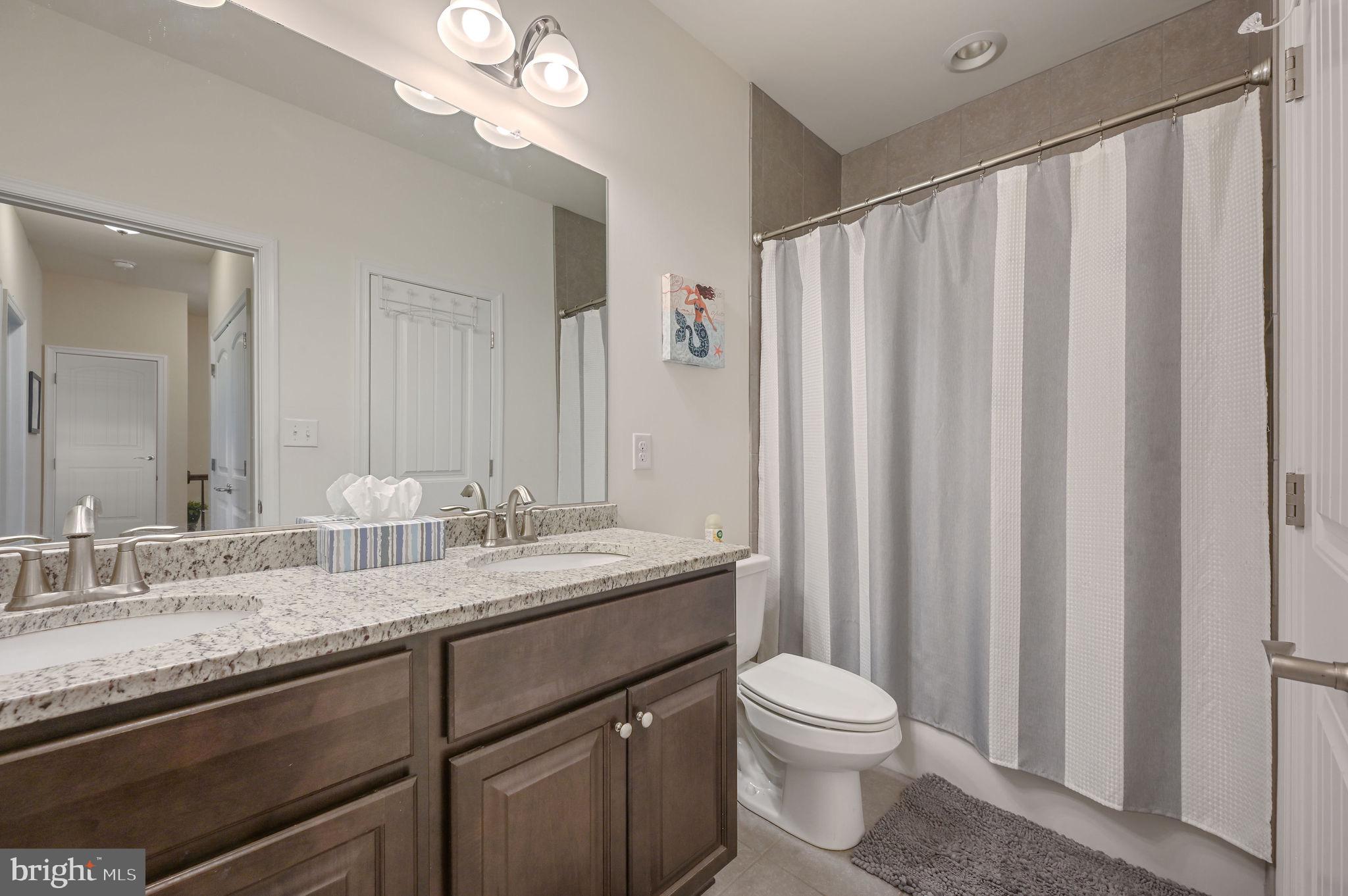 275 Mingo Way Townsend, DE 19734 - Photo 20 of 23 a bathroom with a granite countertop sink a toilet and a mirror