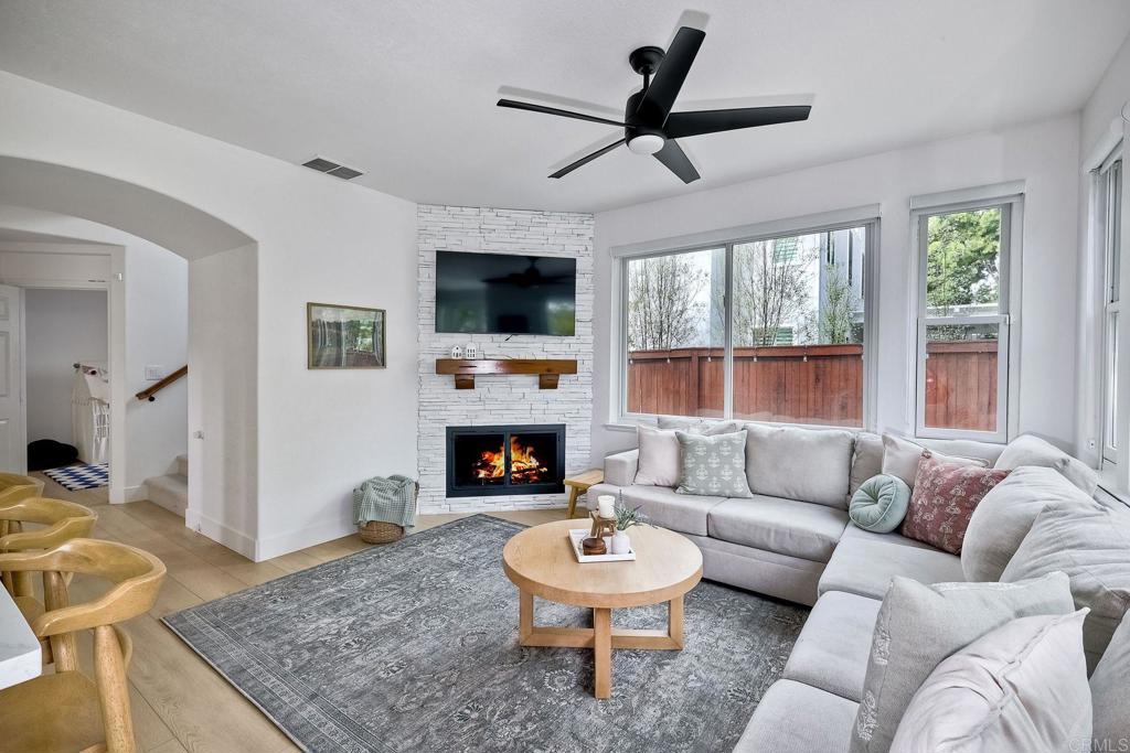 1054 Lighthouse Road Carlsbad, CA 92011 - Photo 12 of 44 a living room with furniture a fireplace and a flat screen tv