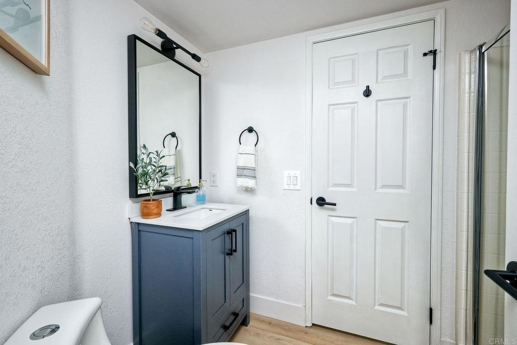1054 Lighthouse Road Carlsbad, CA 92011 - Photo 15 of 44 a bathroom with a sink a mirror and a shower curtain