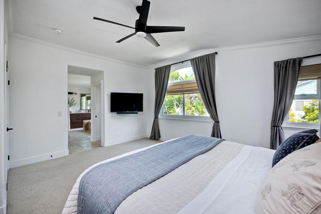 1054 Lighthouse Road Carlsbad, CA 92011 - Photo 18 of 44 a bedroom with a bed and a flat screen tv