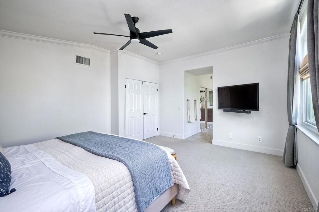 1054 Lighthouse Road Carlsbad, CA 92011 - Photo 19 of 44 a bedroom with a bed and a flat screen tv