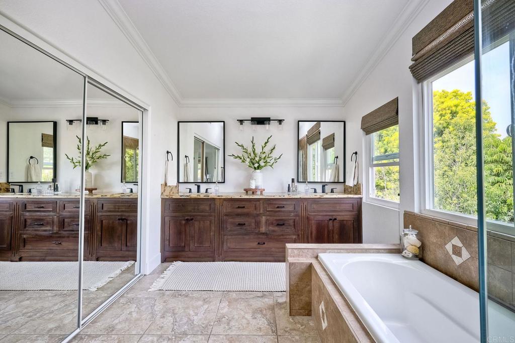 1054 Lighthouse Road Carlsbad, CA 92011 - Photo 20 of 44 a spacious bathroom with a tub sink and mirror