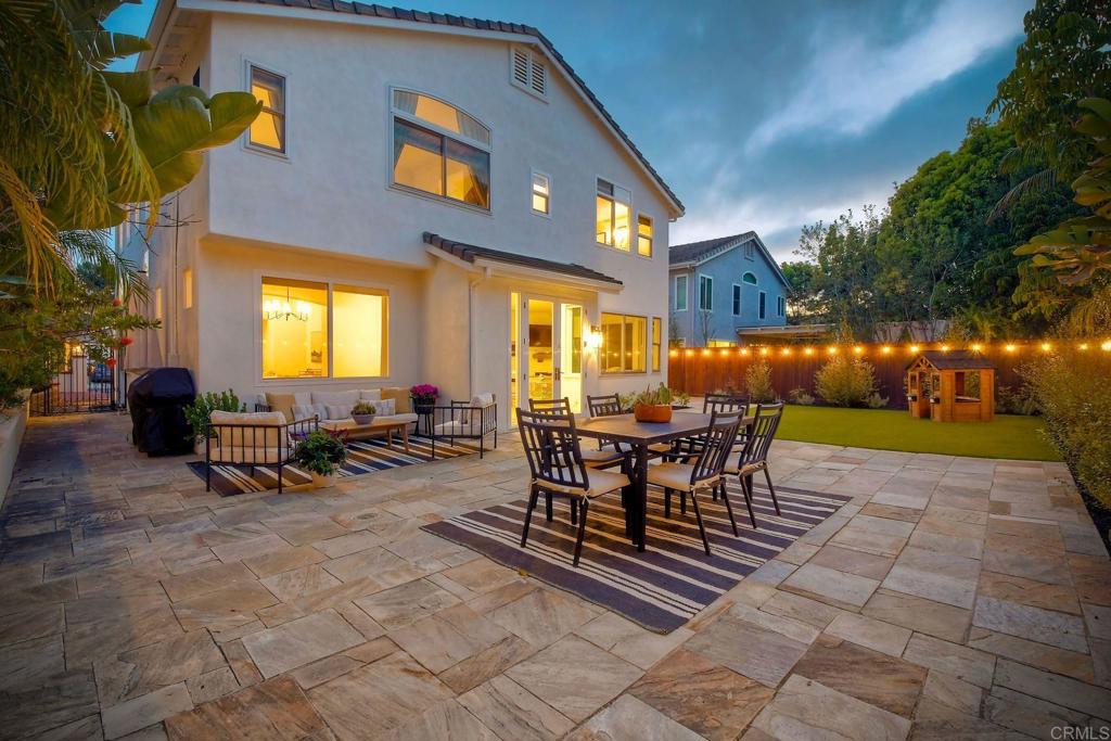 1054 Lighthouse Road Carlsbad, CA 92011 - Photo 28 of 44 a view of a patio with a dining table and chairs with a patio