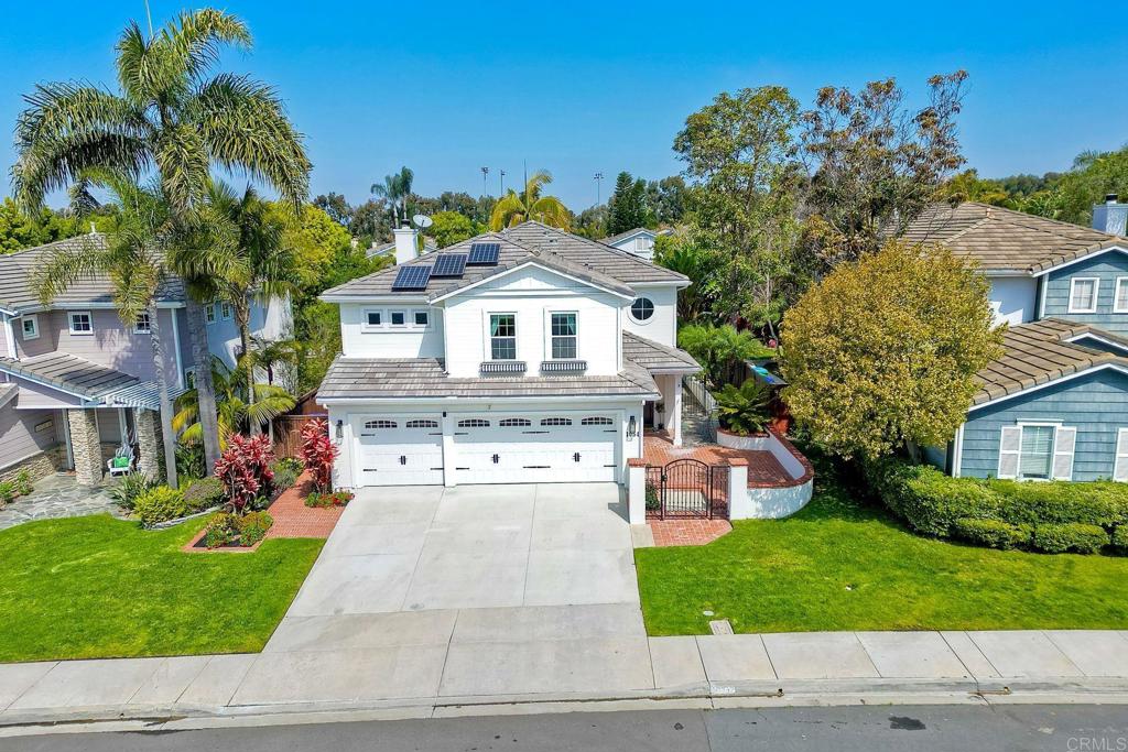 1054 Lighthouse Road Carlsbad, CA 92011 - Photo 36 of 44 a front view of a house with a yard and garage