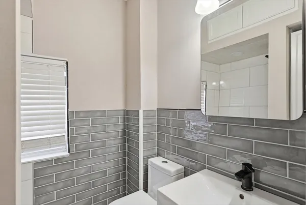 a bathroom with a toilet and a sink