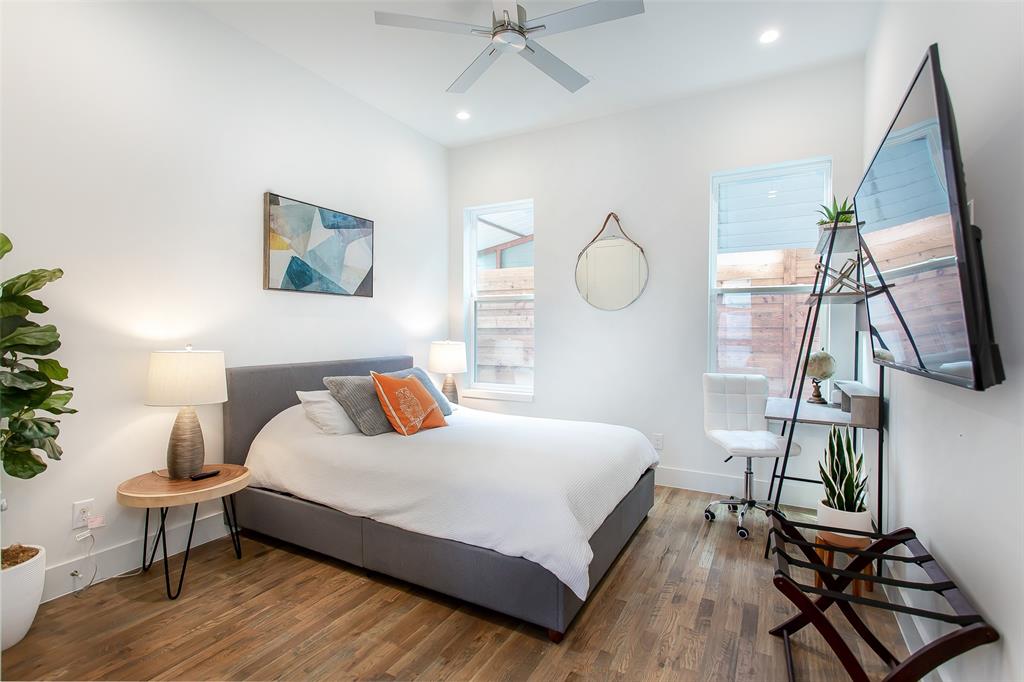 4425 Rusk Avenue Dallas, TX 75204 - Photo 12 of 19 a bedroom with a bed a mirror and a potted plant