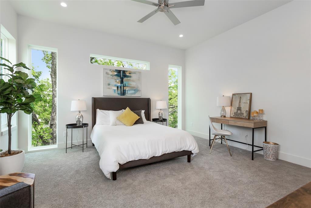 4425 Rusk Avenue Dallas, TX 75204 - Photo 10 of 19 a spacious bedroom with a bed and a table in it