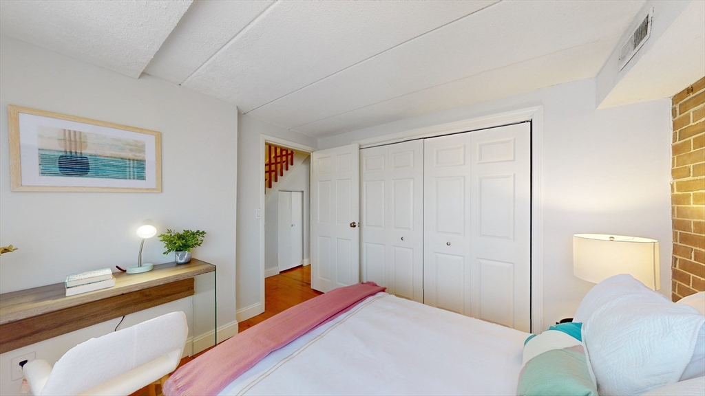 1856 Beacon Street, Unit 6F Brookline, MA 02445 - Photo 12 of 17 a bedroom with a bed and a potted plant