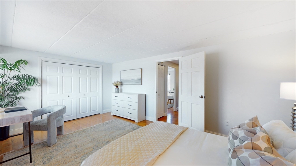 1856 Beacon Street, Unit 6F Brookline, MA 02445 - Photo 13 of 17 a bedroom with a bed and a potted plant