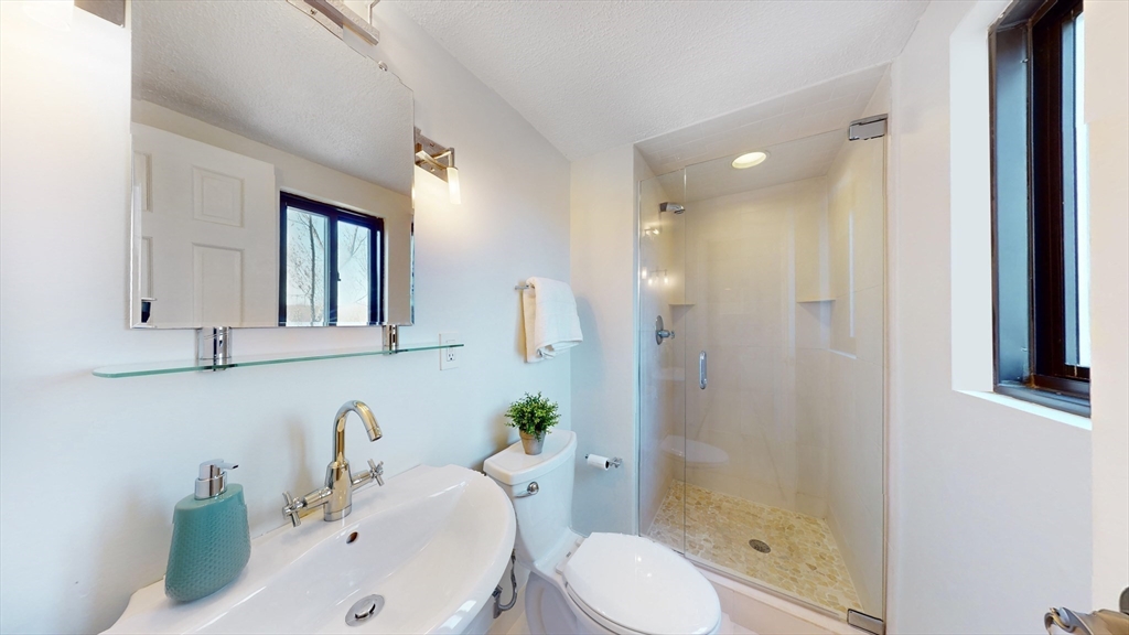 1856 Beacon Street, Unit 6F Brookline, MA 02445 - Photo 3 of 17 a bathroom with a sink toilet and shower
