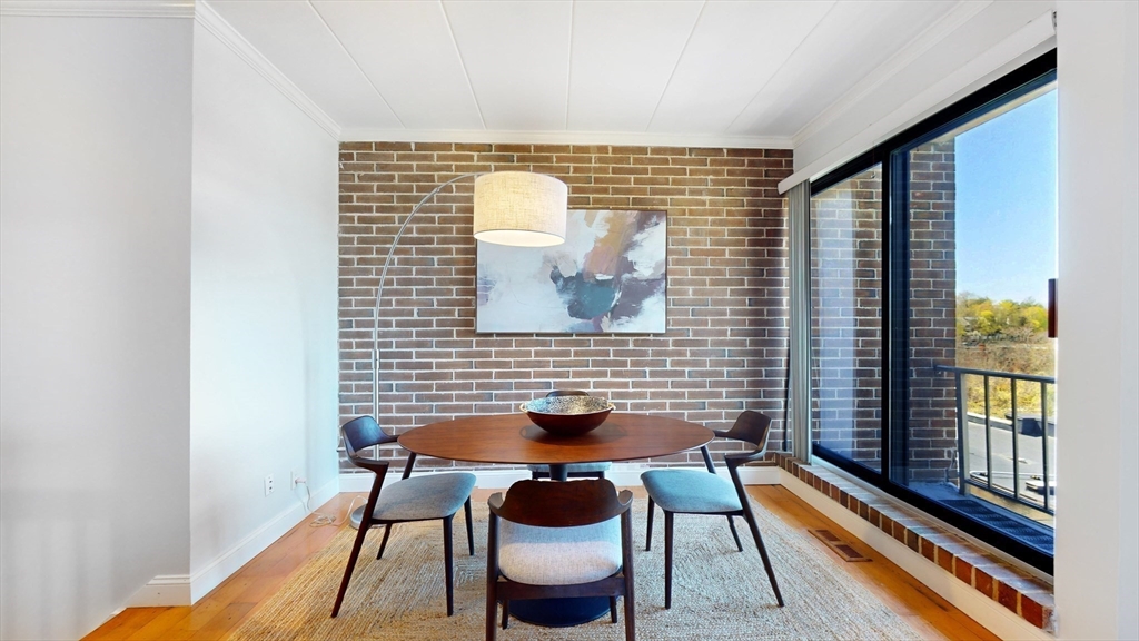 1856 Beacon Street, Unit 6F Brookline, MA 02445 - Photo 5 of 17 a dining room with furniture and wooden floor