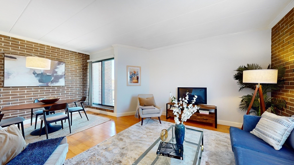 1856 Beacon Street, Unit 6F Brookline, MA 02445 - Photo 6 of 17 a living room with furniture and wooden floor