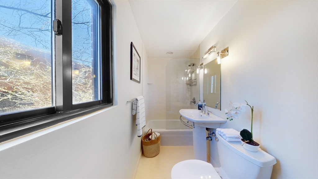 1856 Beacon Street, Unit 6F Brookline, MA 02445 - Photo 10 of 17 a bathroom with a sink mirror and toilet