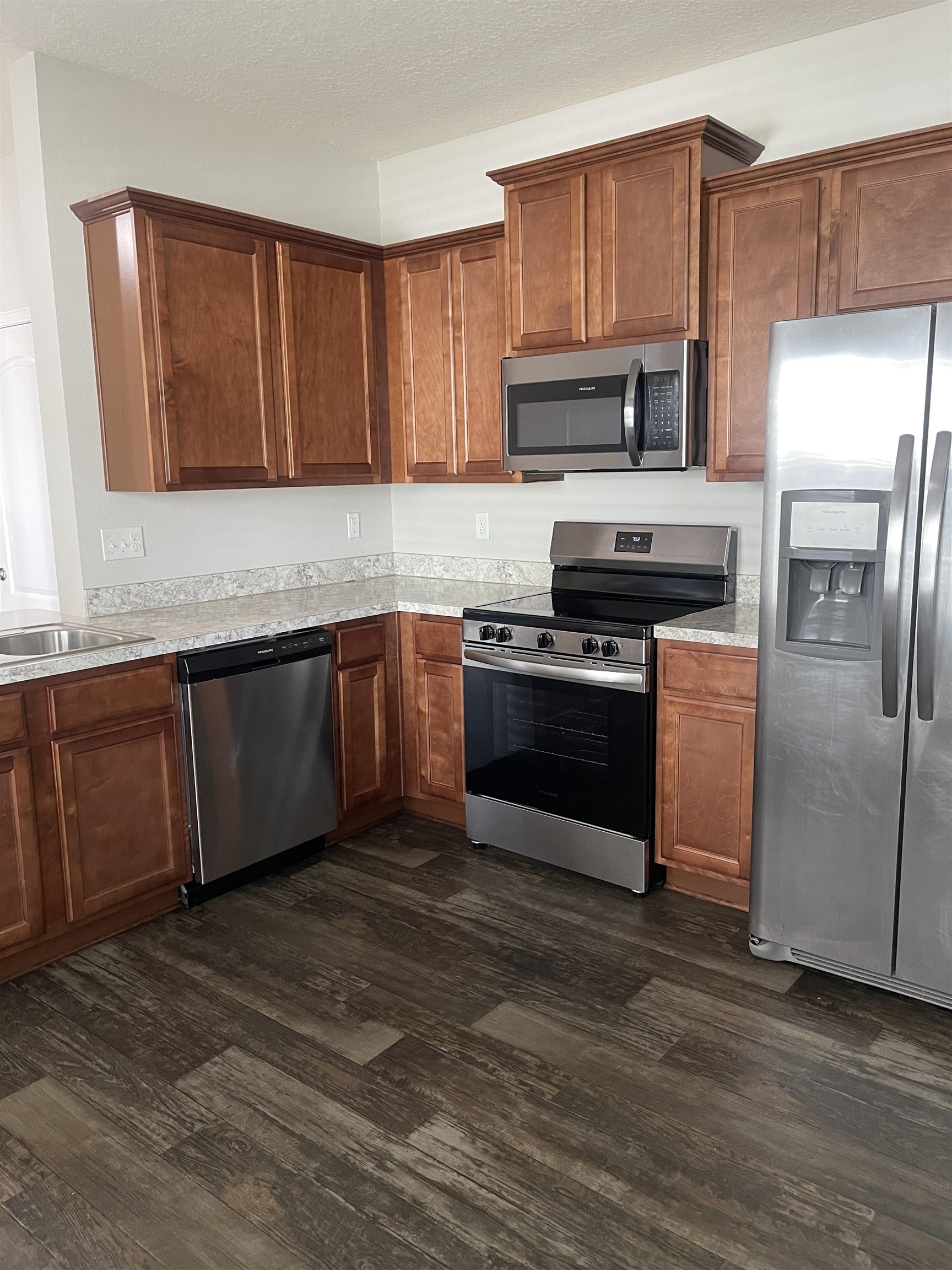 55 Buckley Court St. Augustine, FL 32086 - Photo 16 of 22 a kitchen with wooden cabinets and stainless steel appliances