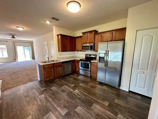 a large kitchen with a large window and stainless steel appliances