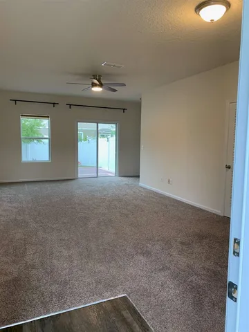 an empty room with windows and closet